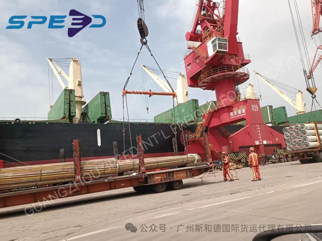 Heavy red port crane lifting scaffolding steel pipes